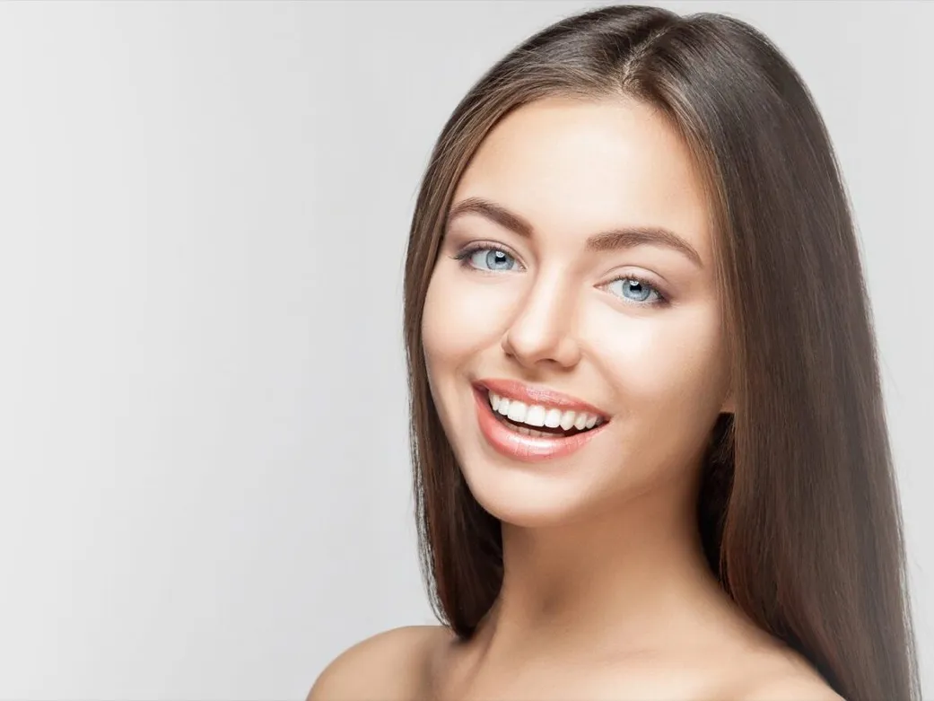 A woman with a bright, white smile.