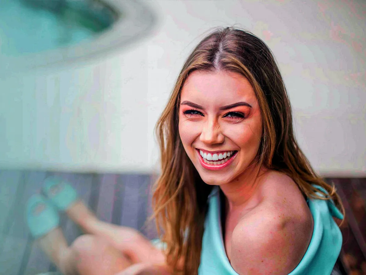 A young woman with a bright, confident smile.